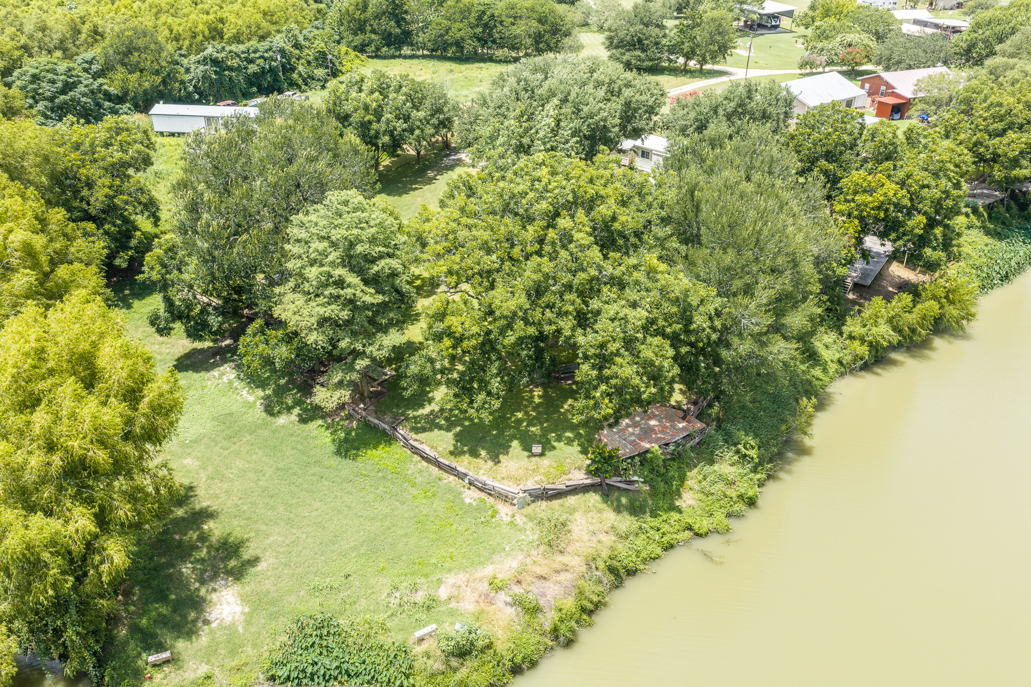 Tbd Goodwin Road Gonzales, TX 78629 - Photo 27 of 33 A tranquil, tree-lined lot offers private waterfront access with verdant surroundings.