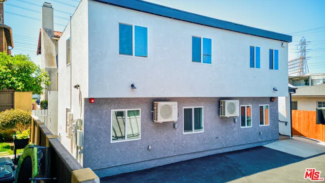 a view of a house with wooden fence