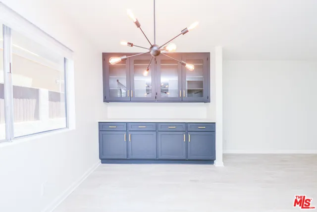 a bathroom with a granite countertop sink mirror and vanity