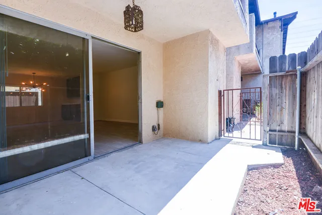 a bathroom with a granite countertop toilet sink and mirror