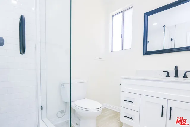 a bathroom with a toilet a sink and a mirror