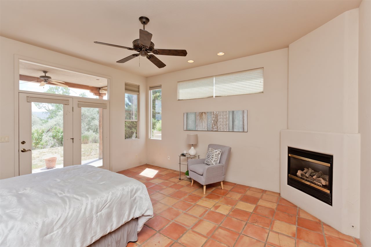 2573 I Road Grand Junction, CO 81505 - Photo 15 of 42 a spacious bedroom with a bed a table and potted plant