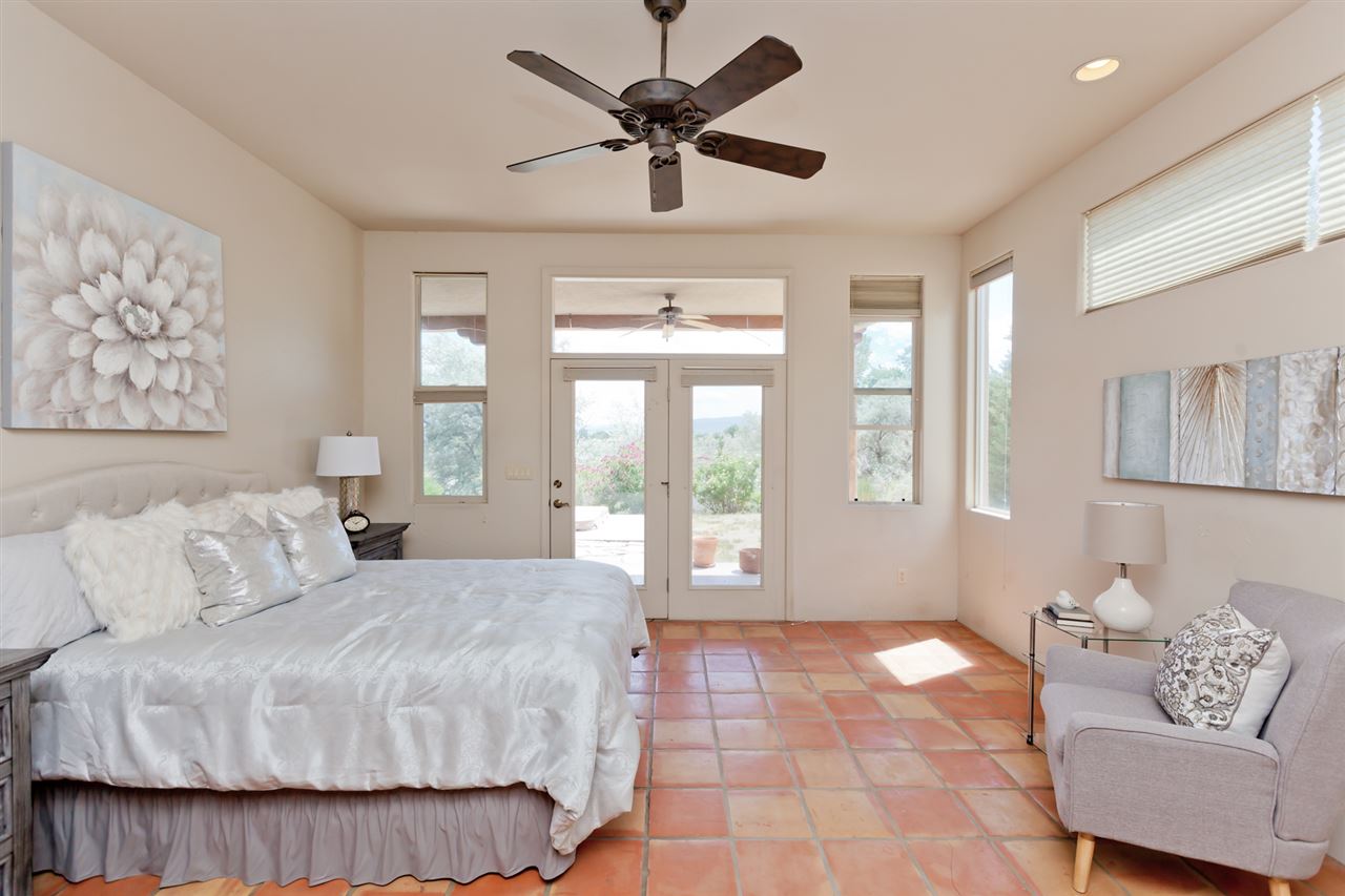 2573 I Road Grand Junction, CO 81505 - Photo 16 of 42 a spacious bedroom with a bed a couch and a window