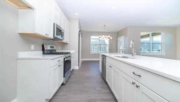 a kitchen with stainless steel appliances granite countertop a stove and a sink