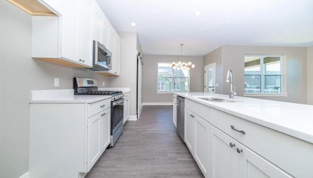 7235 Genesis Way Bettendorf, IA 52722 - Photo 11 of 26 a large kitchen with cabinets and stainless steel appliances