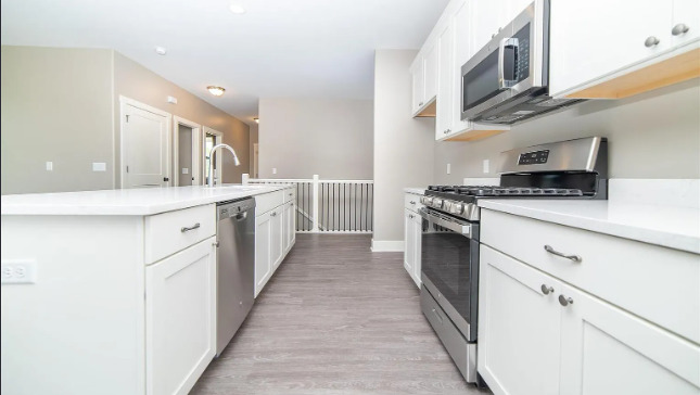 7235 Genesis Way Bettendorf, IA 52722 - Photo 12 of 26 a kitchen with stainless steel appliances granite countertop a stove and a sink