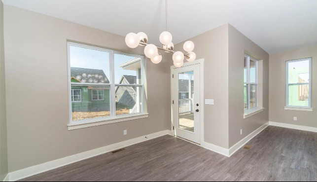 7235 Genesis Way Bettendorf, IA 52722 - Photo 14 of 26 a view of an empty room with wooden floor and a window