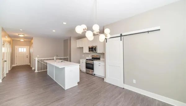 wooden floor fireplace and windows in an empty room