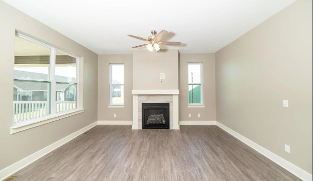 7235 Genesis Way Bettendorf, IA 52722 - Photo 16 of 26 wooden floor fireplace and windows in an empty room