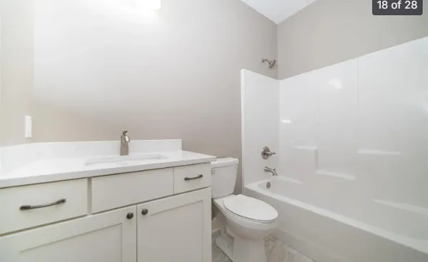 a bathroom with a bathtub and a toilet