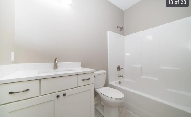 7235 Genesis Way Bettendorf, IA 52722 - Photo 17 of 26 a bathroom with a sink a toilet and shower