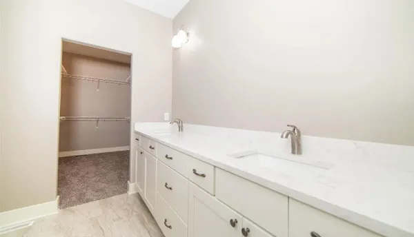 a bathroom with a double vanity sink and a mirror