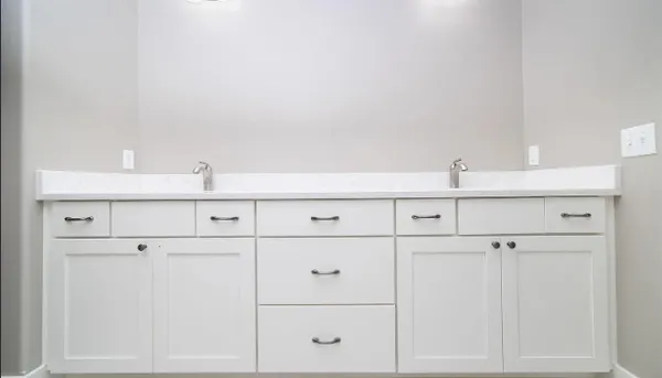 a large kitchen with cabinets and stainless steel appliances