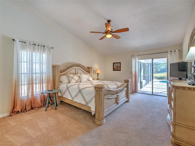 a spacious bedroom with a bed a couch and a window