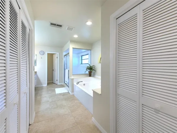 a bathroom with a tub shower and vanity