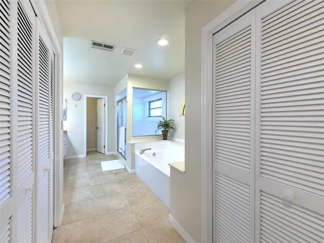a bathroom with a tub shower and vanity