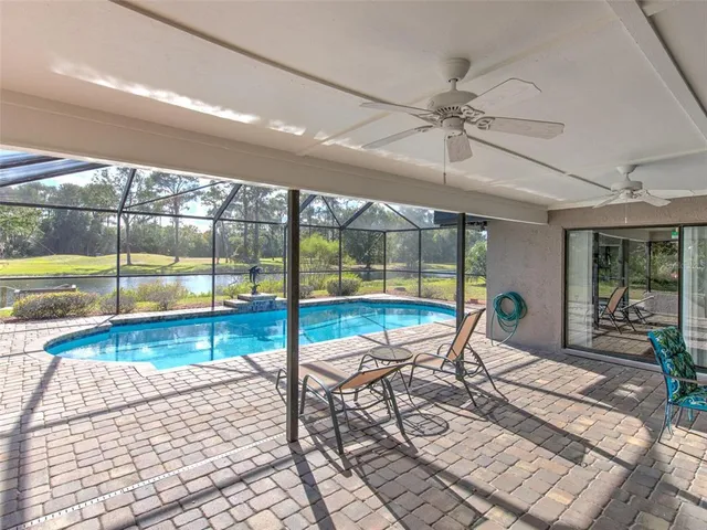 a living room with a floor to ceiling window and pool table