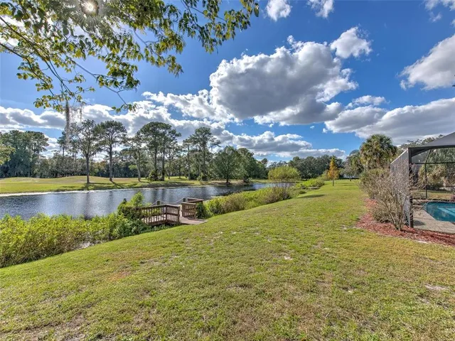 a view of a lake with houses in the back