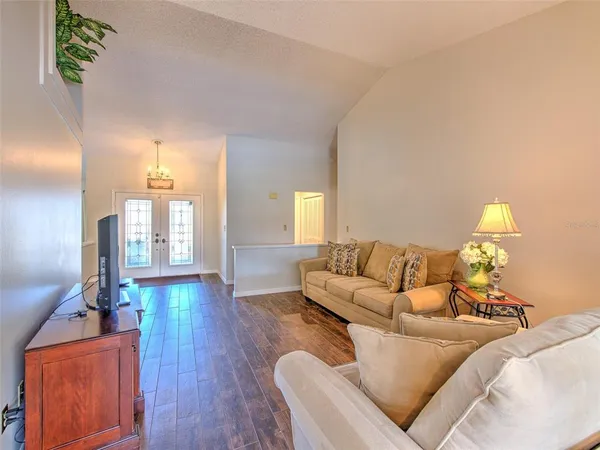 a living room with furniture and a wooden floor