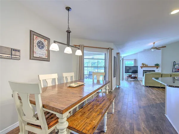 a dining room with furniture and wooden floor