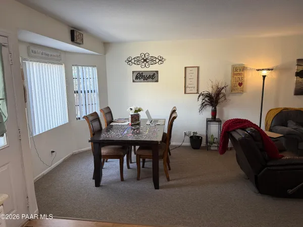 a dining room with furniture and window