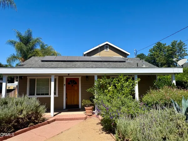 front view of a house with potted plants