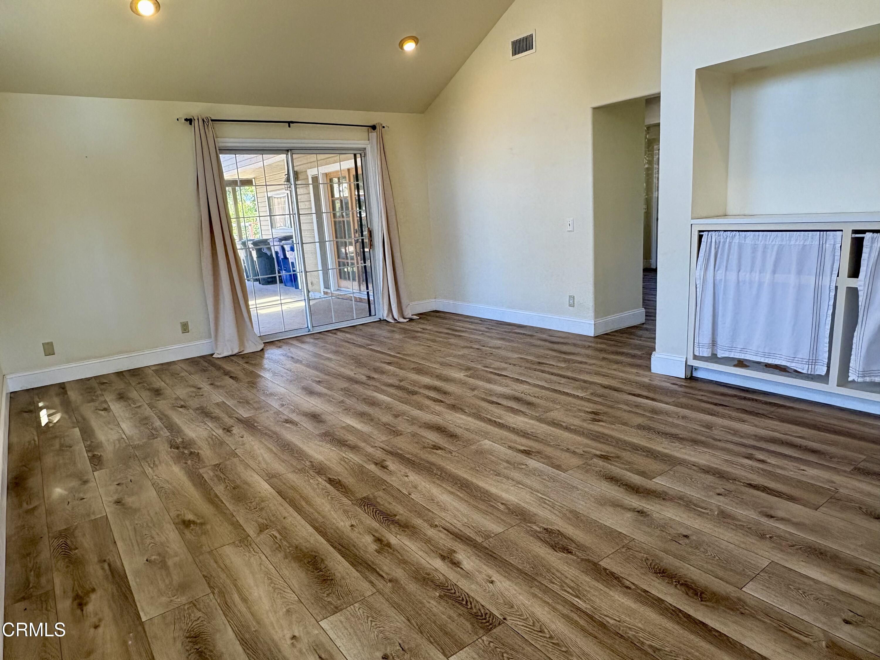 133 Prospect Street Oak View, CA 93022 - Photo 5 of 19 a view of an empty room with wooden floor and a window