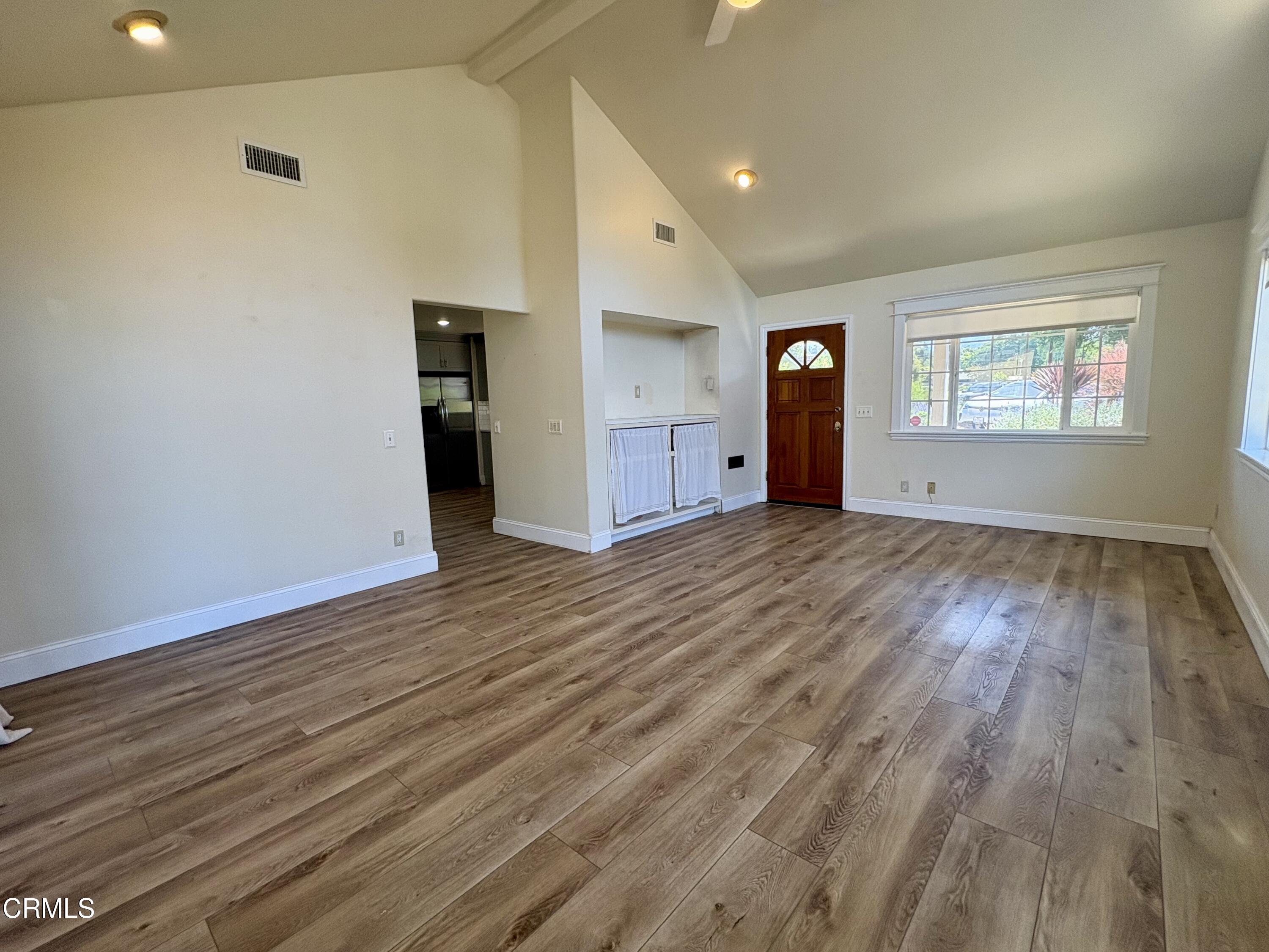 133 Prospect Street Oak View, CA 93022 - Photo 6 of 19 an empty room with wooden floor and windows