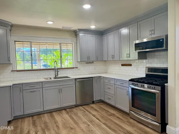 a kitchen with appliances cabinets and a sink