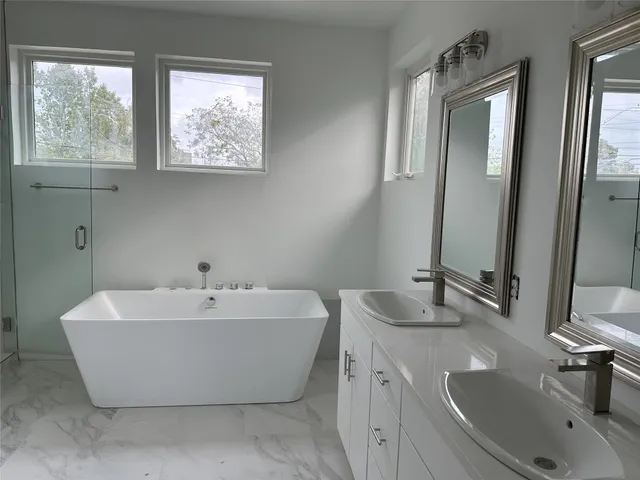 a bath tub sitting next to a bathroom sink