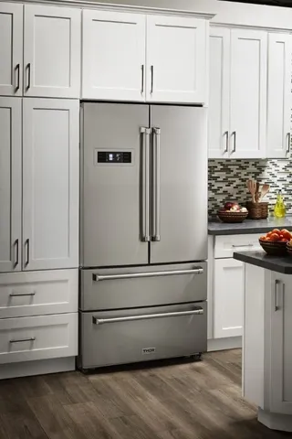 a close view of a kitchen with appliances and cabinets