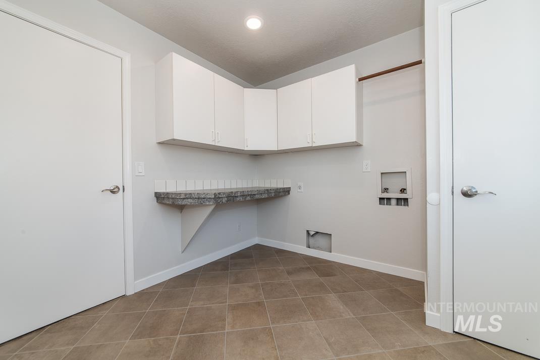 480 Easy Street Kuna, ID 83634 - Photo 13 of 39 Laundry area with hookup for a washing machine and cabinet space