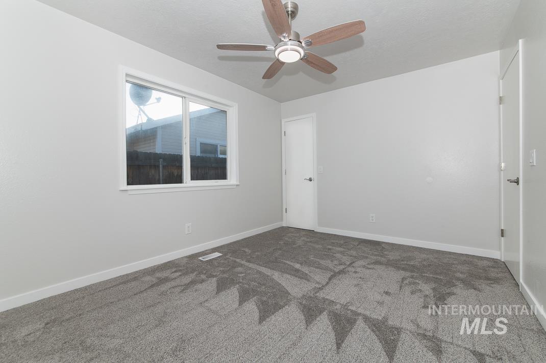 480 Easy Street Kuna, ID 83634 - Photo 17 of 39 Carpeted empty room featuring baseboards and a ceiling fan