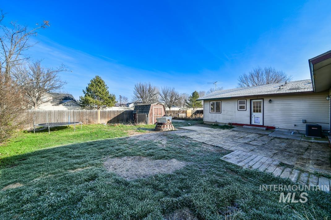 480 Easy Street Kuna, ID 83634 - Photo 36 of 39 Fenced backyard featuring a trampoline, a patio, and a storage shed