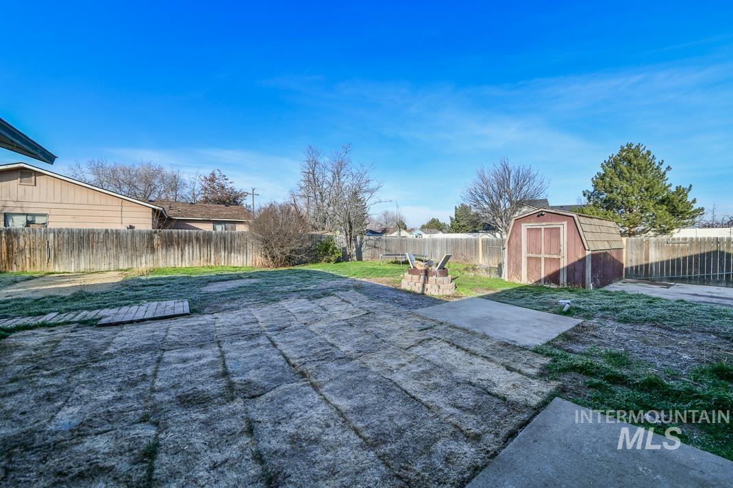 480 Easy Street Kuna, ID 83634 - Photo 38 of 39 Fenced backyard with a storage shed and a patio