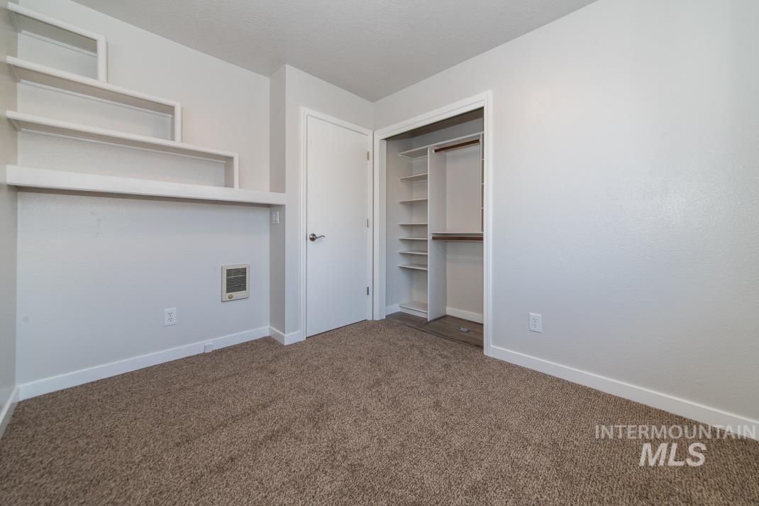 480 Easy Street Kuna, ID 83634 - Photo 10 of 39 Unfurnished bedroom with dark colored carpet and a closet
