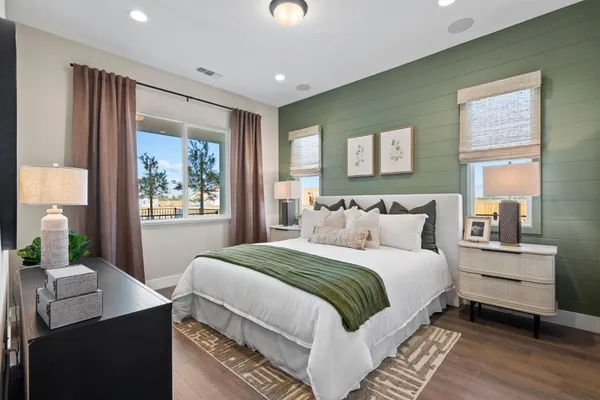a bedroom with a bed and a mirror