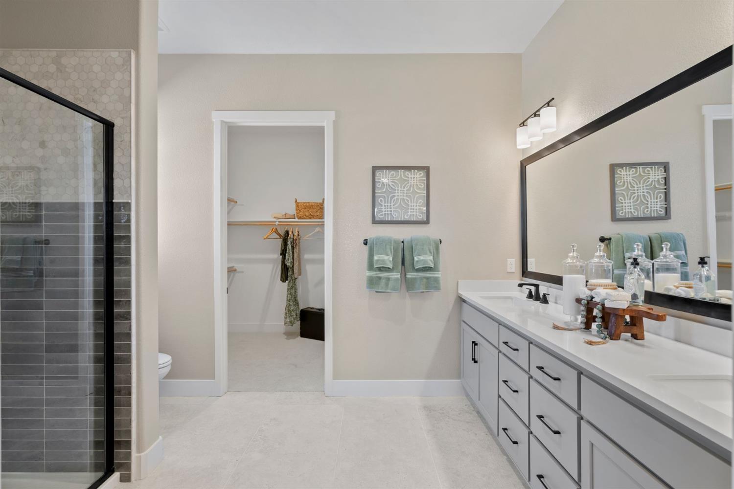 1838 Foster Lane Davis, CA 95616 - Photo 23 of 56 a spacious bathroom with double vanity a mirror and a shower