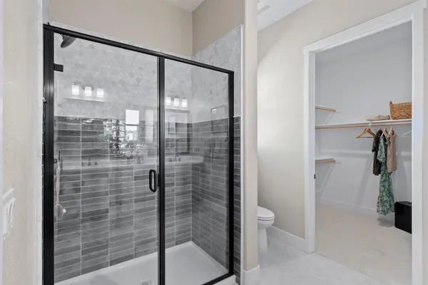 a bathroom with a shower and a glass door