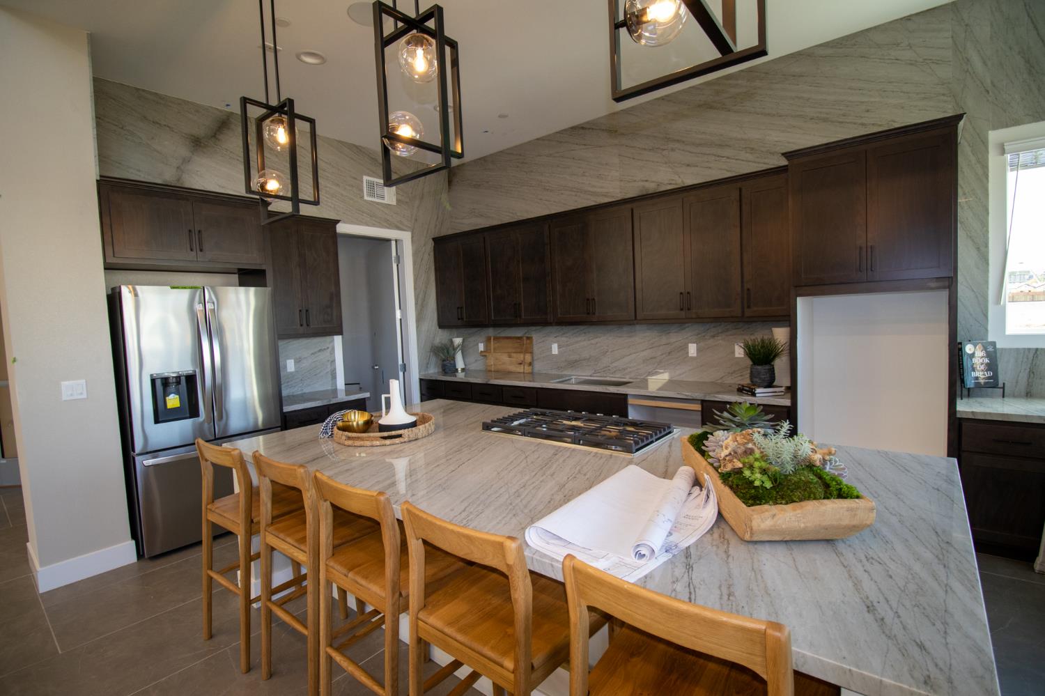 1838 Foster Lane Davis, CA 95616 - Photo 52 of 56 a kitchen with stainless steel appliances kitchen island granite countertop a table chairs in it and wooden floors