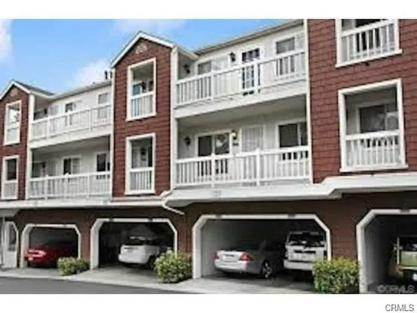 a front view of a building with parking space