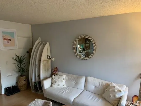 a living room with furniture and a mirror