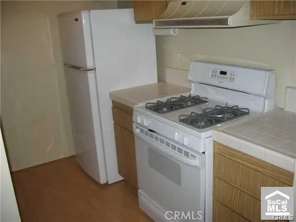 a kitchen with a stove and a refrigerator