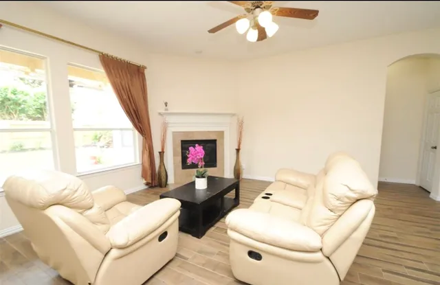 a living room with furniture and a large window