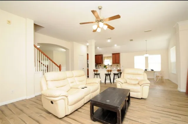 a living room with furniture and kitchen view