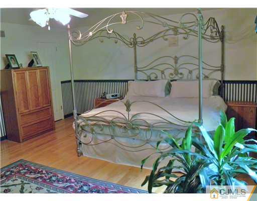 293 Friendship Road Cranbury, NJ 08512 - Photo 5 of 10 a bed sitting in a bedroom next to a window