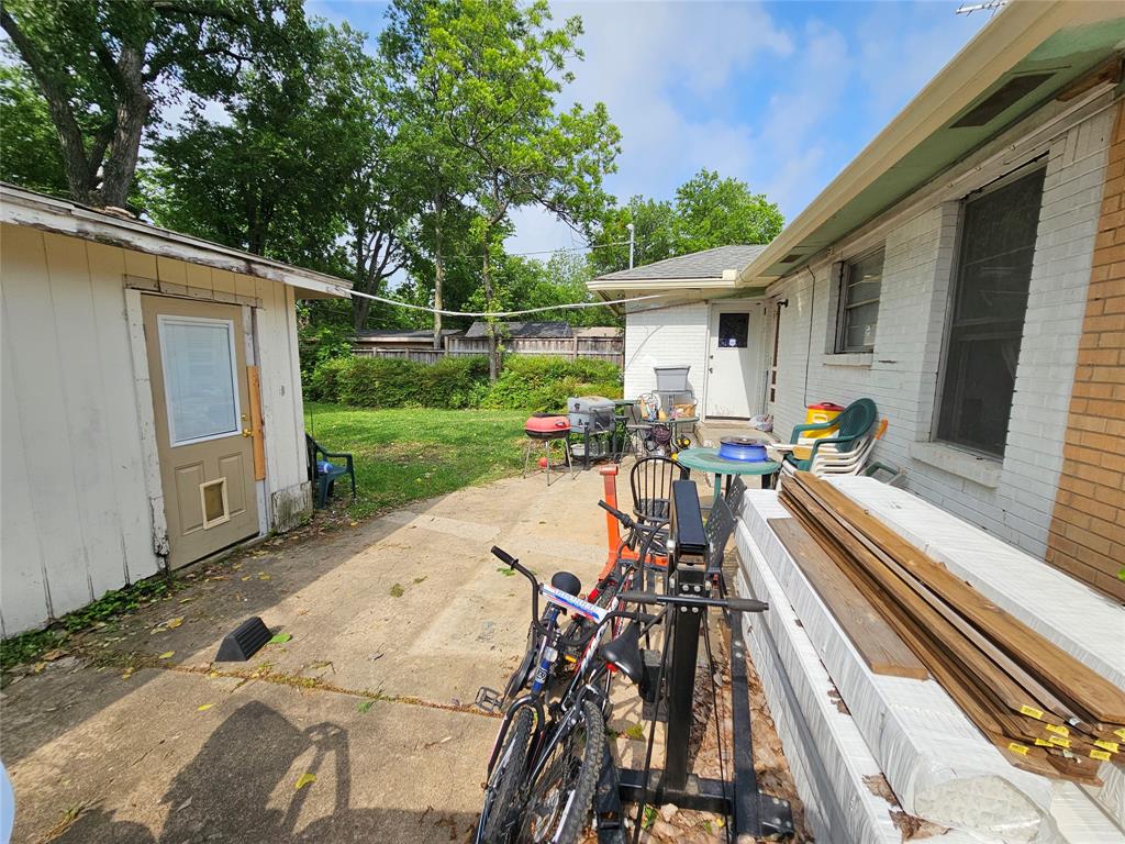 2714 Crest Ridge Drive Dallas, TX 75228 - Photo 14 of 15 Rear patio area featuring a detached storage shed with a panel door, a concrete patio surface, and a fenced perimeter