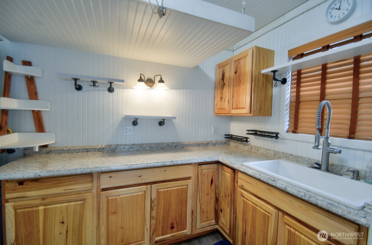 1546 Reservation Road Southeast, Unit 249 Olympia, WA 98513 - Photo 17 of 37 a kitchen with a sink and cabinets