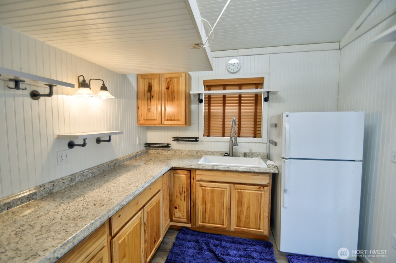 1546 Reservation Road Southeast, Unit 249 Olympia, WA 98513 - Photo 18 of 37 a kitchen with a sink a refrigerator and a stove