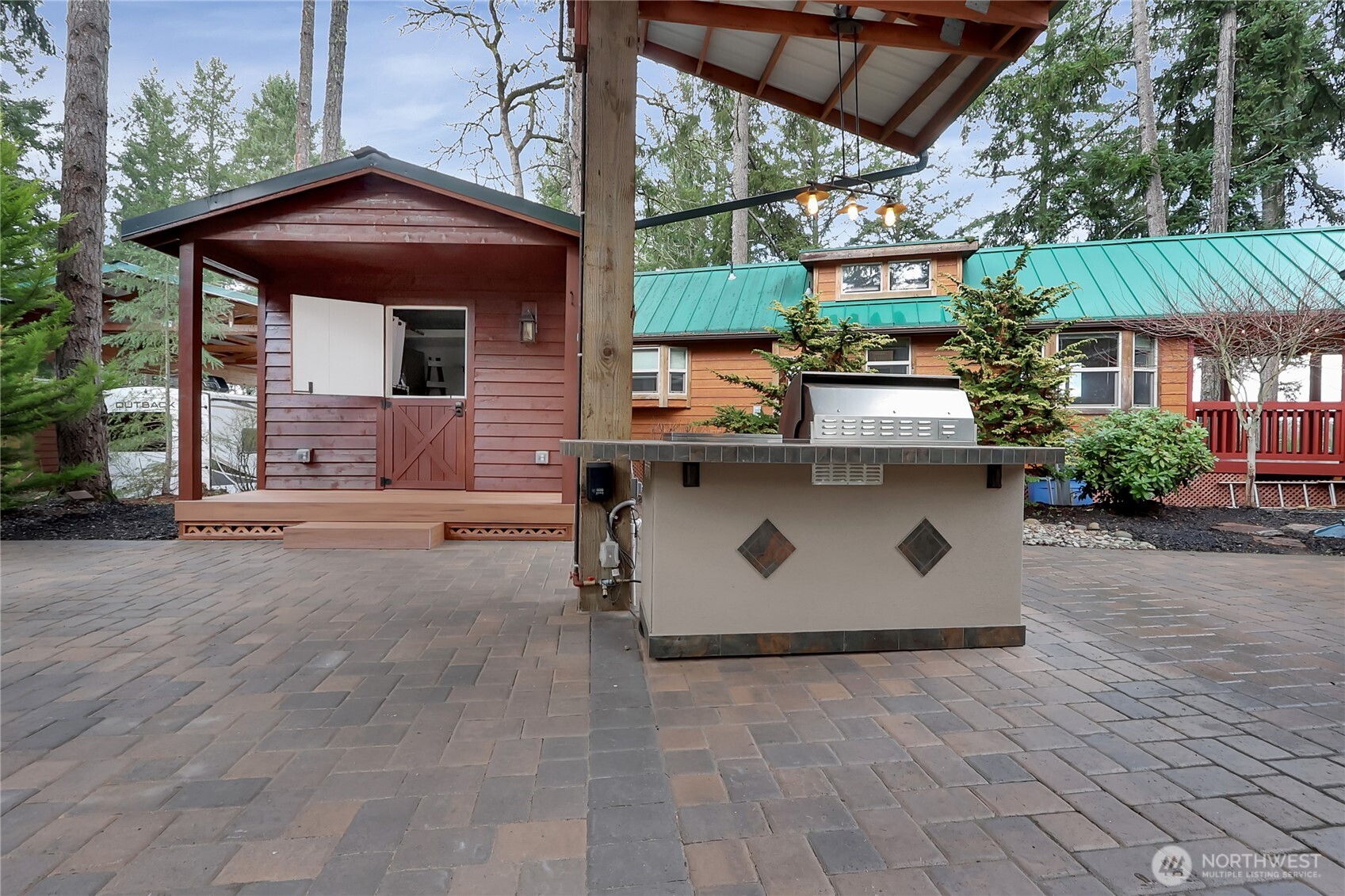 1546 Reservation Road Southeast, Unit 249 Olympia, WA 98513 - Photo 6 of 37 a view of a house with a sink and table under an umbrella